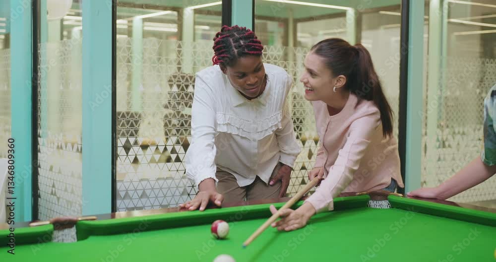 Indian happy young adult gen z woman lady hold cue stick hit ball play sport game on pool table after work girl female staff give high five enjoy good break spend day time have fun joy job place
