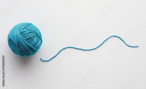 Knitting Yarn Ball with Loose Strand on Clean White Background