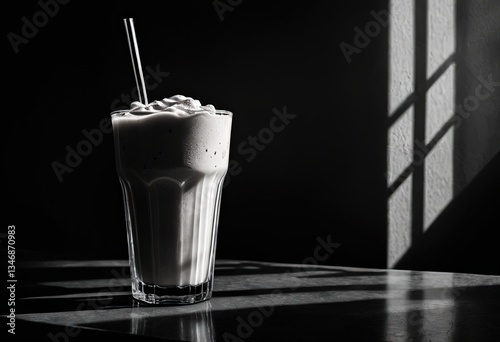 A black and white image of a milkshake