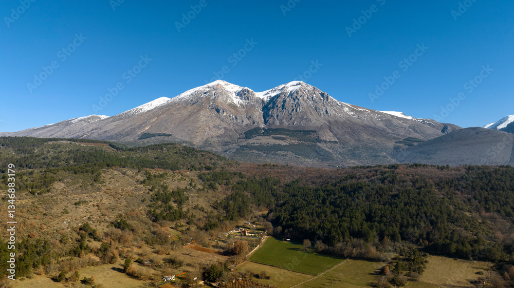 Naklejka premium Aerial view of the Velino mountain range, in Abruzzo. It is the highest mountain in central Italy. The mountain peaks are snow-capped.