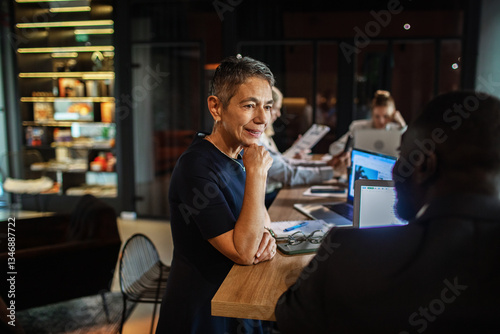 Confident mature businesswoman in meeting at modern office