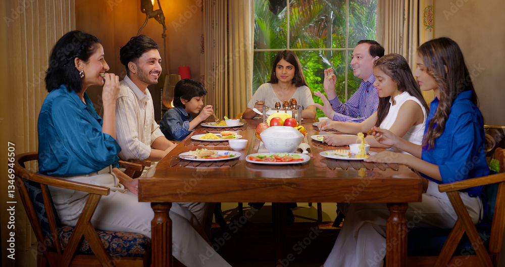 Indian happy family group with cute kid child sitting around dining table chair enjoy night dinner adult dad teen girl young boy talk mom lady serve fresh salad eat tasty food have fun joy spend time Indian happy family group with cute kid child sitting around dining table chair enjoy night dinner adult dad teen girl young boy talk mom lady serve fresh salad eat tasty food have fun joy spend time