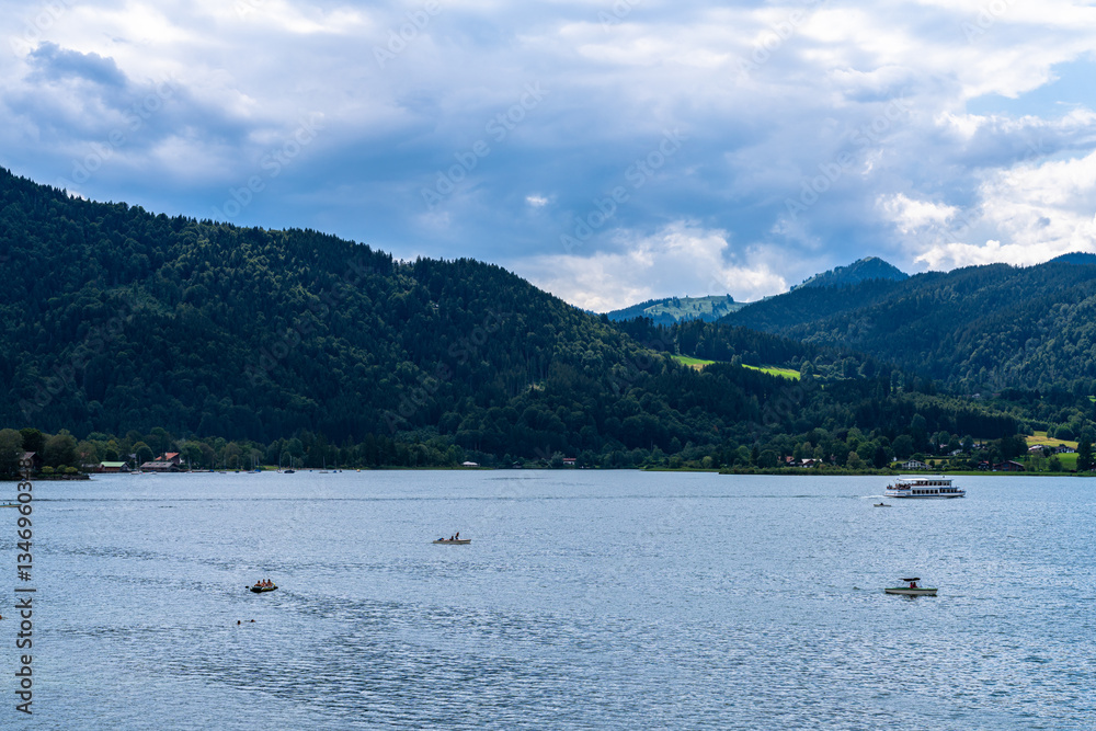 Idyllic panorama view of Tegernsee lake with Bavarian alps in background on a sunny summer day, Tegernsee, Bavaria, Germany Idyllic panorama view of Tegernsee lake with Bavarian alps in background on a sunny summer day, Tegernsee, Bavaria, Germany