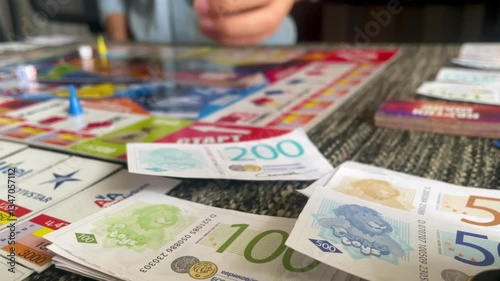 Playing a Board Game with Play Money, Strategy and Fun for the Whole Family
