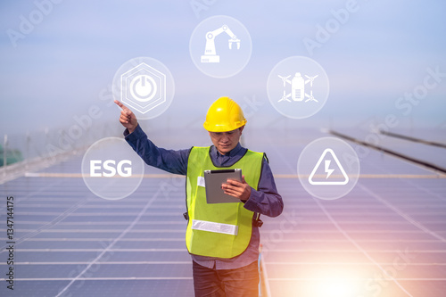 Obraz na płótnie A solar energy engineer inspects photovoltaic panels using digital technology to drive a sustainable future with ESG standards.