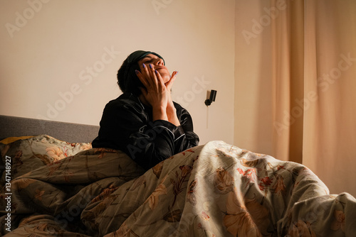 Cuadro en lienzo Smiling, she removes her sleep mask, enjoying the cozy morning light
