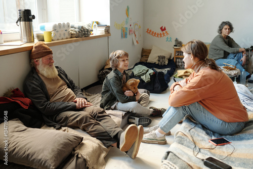 Quadro em tela Happy cute child with toy looking at his mother during talk while both sitting o