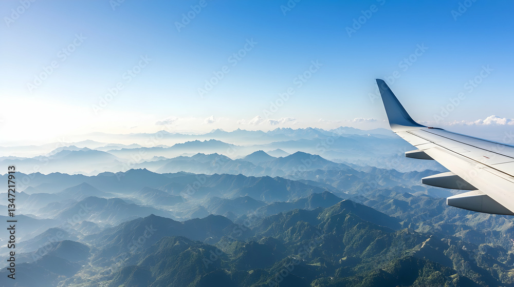 Fototapeta premium Aerial View Of Misty Mountains From Airplane Window