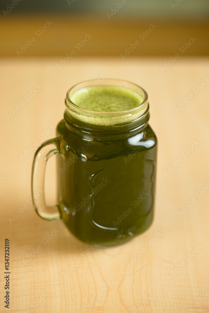 Refreshing green smoothie with foam in a mason jar Refreshing green smoothie with foam in a mason jar