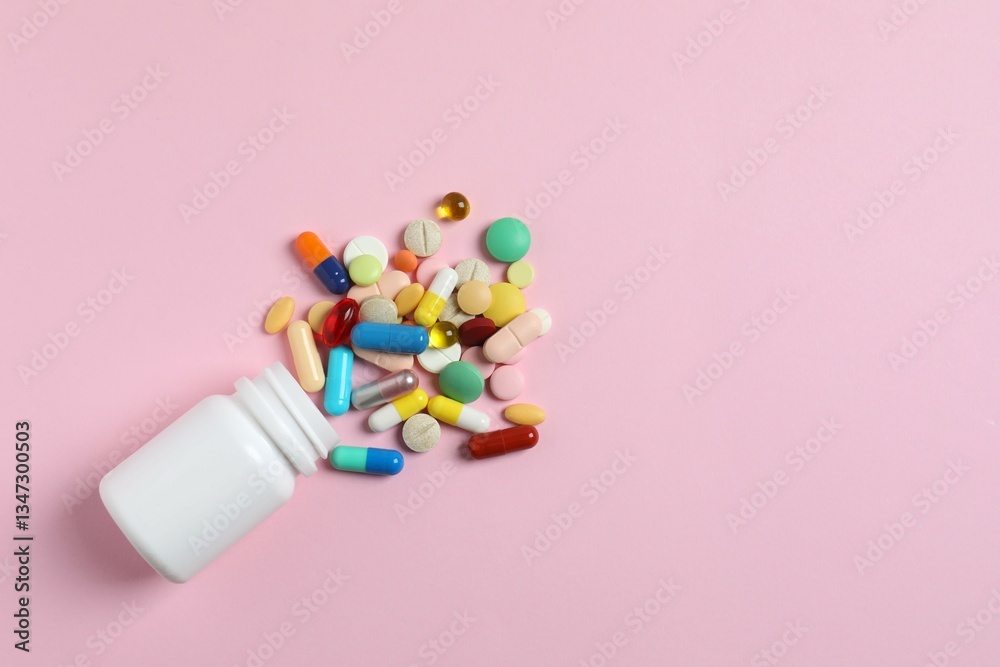 Various pills with white bottle on color background, top view Various pills with white bottle on color background, top view