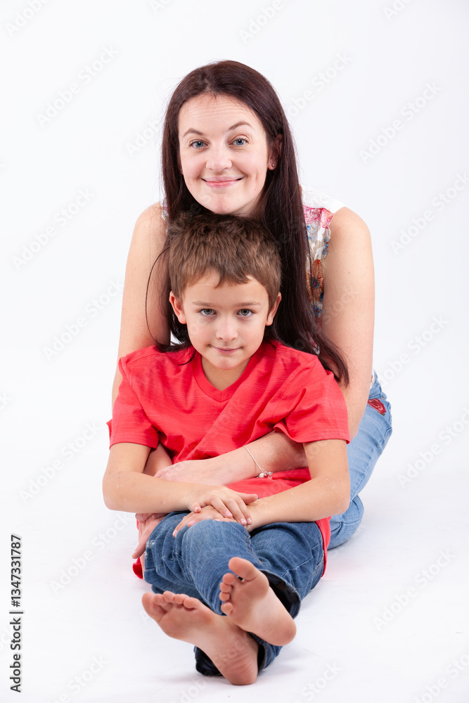 A woman and a boy are sitting on the floor A woman and a boy are sitting on the floor