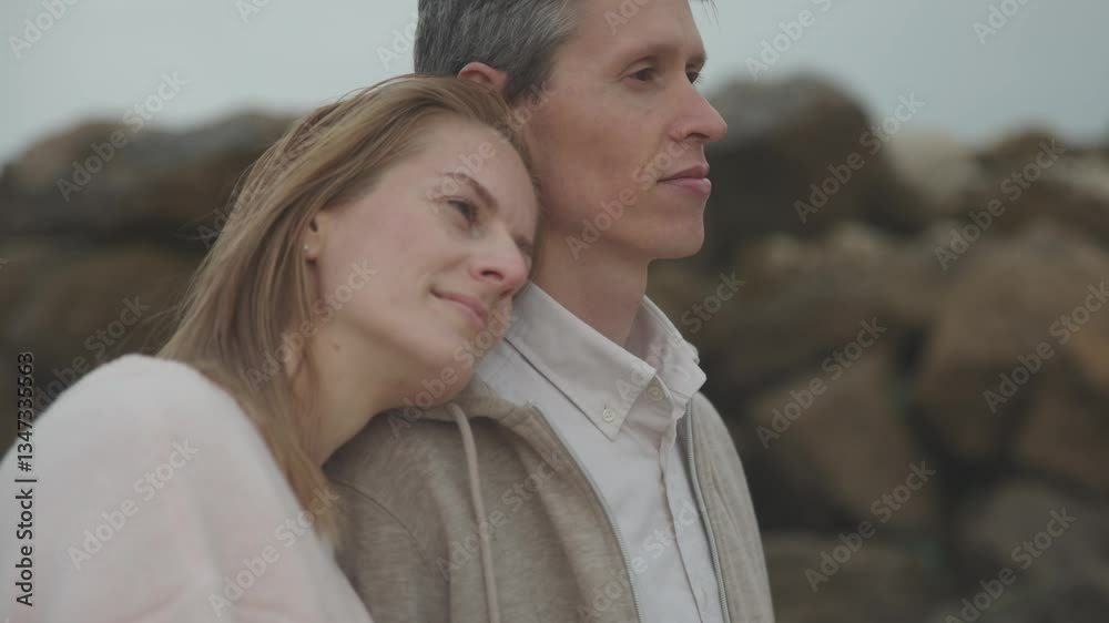 Romantic couple embracing on rocky beach Romantic couple embracing on rocky beach