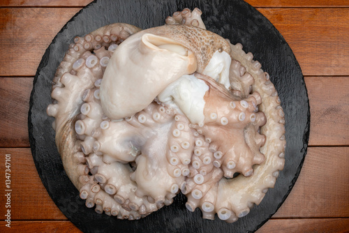 Raw octopus on the plate, flat lay
