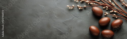Decorative Brown Eggs and Willow Branches Arranged on Dark Textured Surface f...