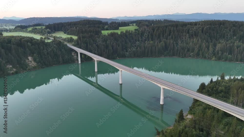 Flight over road bridge Lechtal bridge (Lechtalbrücke Schongau) and river Lech with mountain alps panorama in the morning during sunrise, Germany