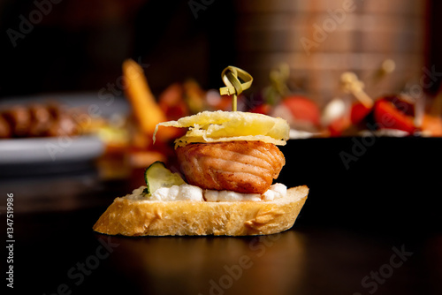 Grilled sandwich with smoked red fish, bruschetta, soft cheese on a skewer.