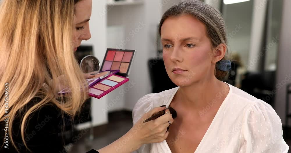 Make up artist doing professional make up of young woman. Make up artist doing professional make up of young woman.