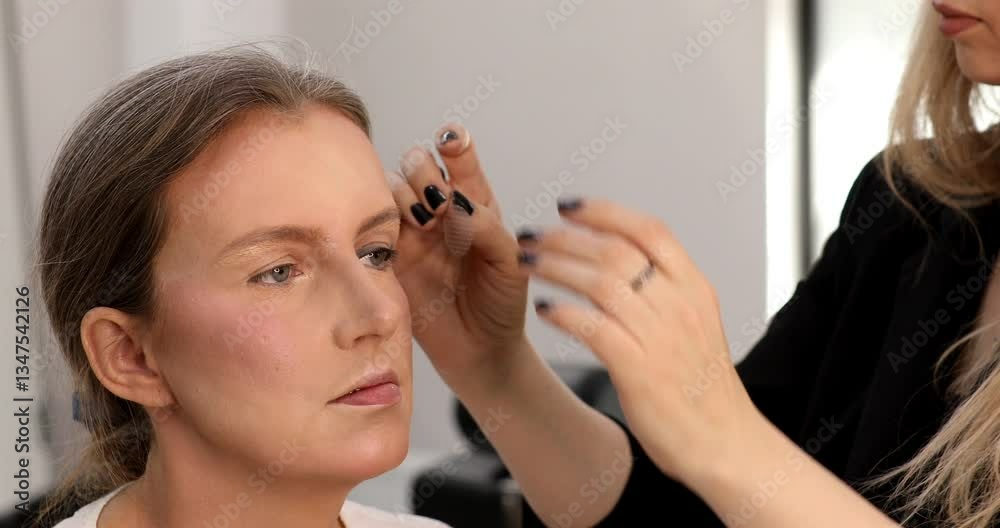 Women with heavy make up looking into camera and closing eyes, portrait. Makeup tape on face lifting eye. 