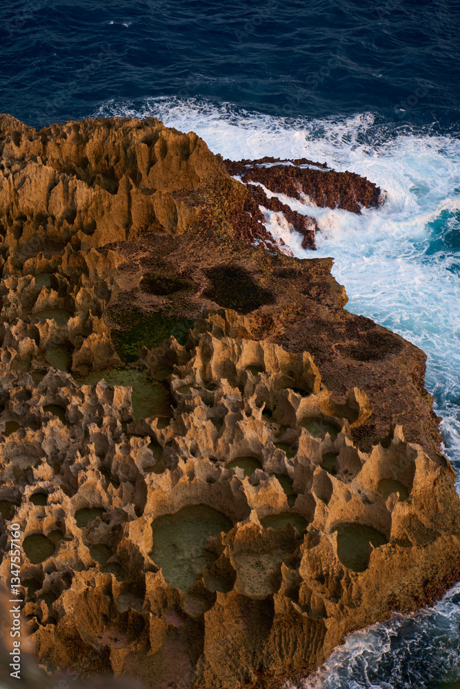 Cinematic aerial landscape shots of the beautiful island of Nusa Penida. Huge cliffs by the shoreline and hidden dream beaches with clear water and foaming wave.