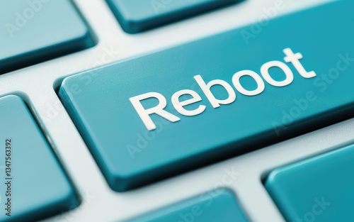 Close up of a teal keyboard key that says Reboot a fresh start for your computer system