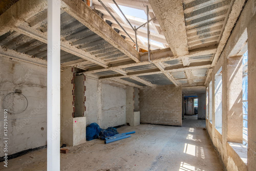 Interior construction site with exposed framework and tools Interior construction site with exposed framework and tools
