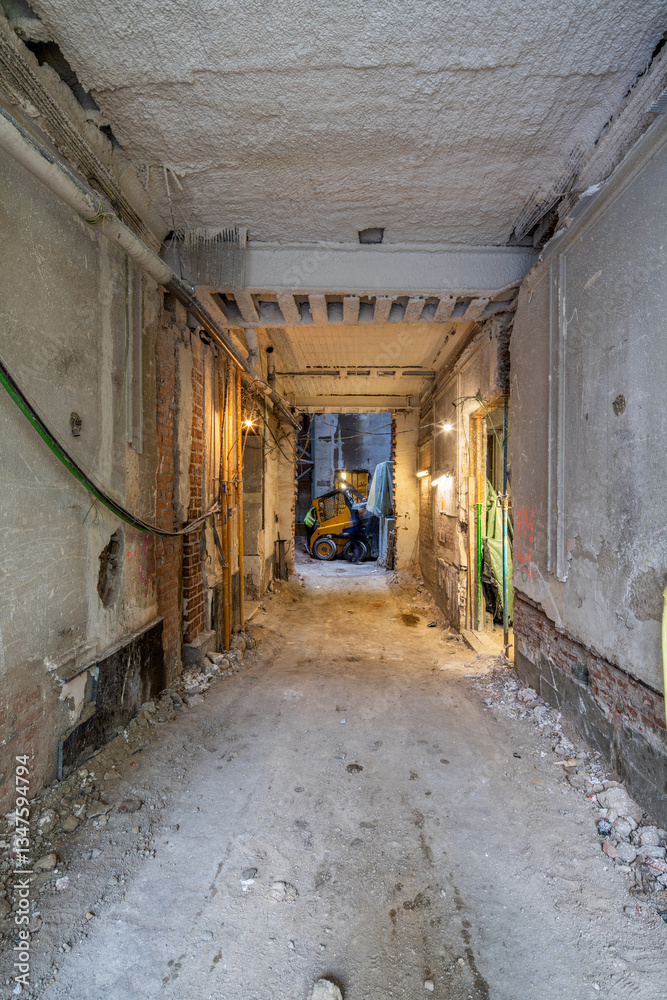 Construction site interior showing renovation progress and tools Construction site interior showing renovation progress and tools
