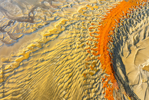 Abstract Aerial View of Vibrant Orange and Yellow Sand Patterns