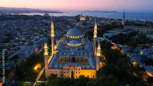 Aerial view of Istanbul at dawn with the illuminated Süleymaniye Mosque, Marmara Sea, Hagia Sophia, Blue Mosque, and Beyazit Tower in the background