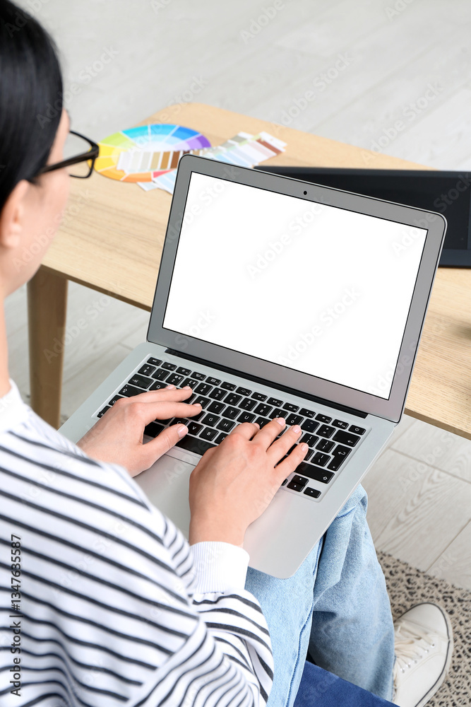 Fototapeta premium Female web designer working with laptop