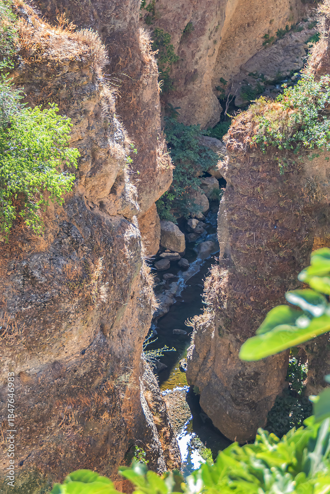 The rocky, sheer-sided limestone cliffs of Ronda Gorge (El Tajo de Ronda) plummet 390 feet (120 meters) to Guadalevin River. Ronda, Province of Malaga, Spain.