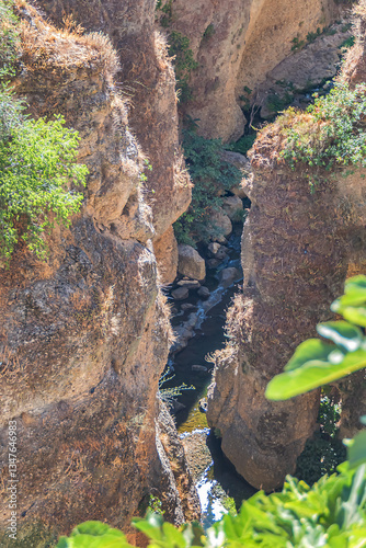 Obraz na płótnie The rocky, sheer-sided limestone cliffs of Ronda Gorge (El Tajo de Ronda) plummet 390 feet (120 meters) to Guadalevin River. Ronda, Province of Malaga, Spain. w salonie