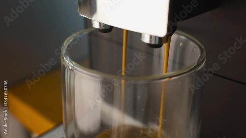 Coffee machine filling a cup with. Making coffee into cup, espresso coming out from an automatic coffee maker machine. Beverage drink for breakfast