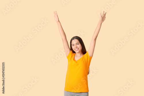 Happy young woman in orange...