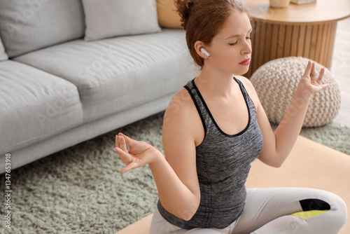 Sporty young woman meditati...