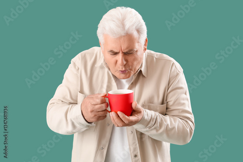 Mature man with cup of hot ...