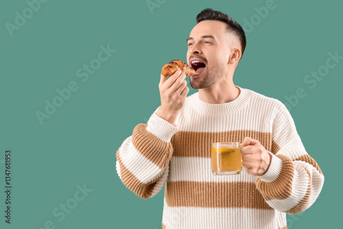 Young man with cup of tea e...