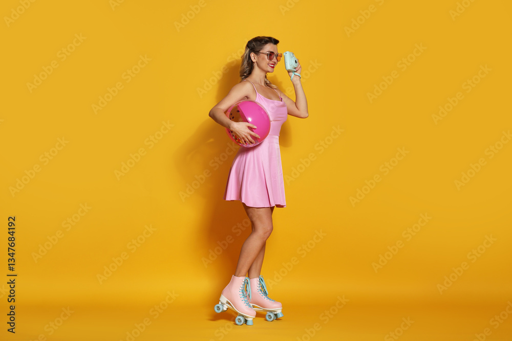 Happy woman with camera and inflatable ball on orange background. Pin-up vibes Happy woman with camera and inflatable ball on orange background. Pin-up vibes