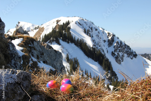 Obraz na płótnie easter nest with colorful eggs, blurry alps background w salonie