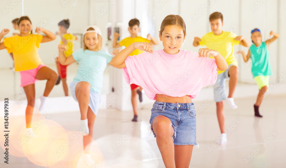 Naklejka premium Group of children are learning dance moves in a modern studio