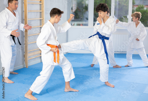 Konstfotografi Willing junior attendee of karate classes fighting with his opponent in sports h