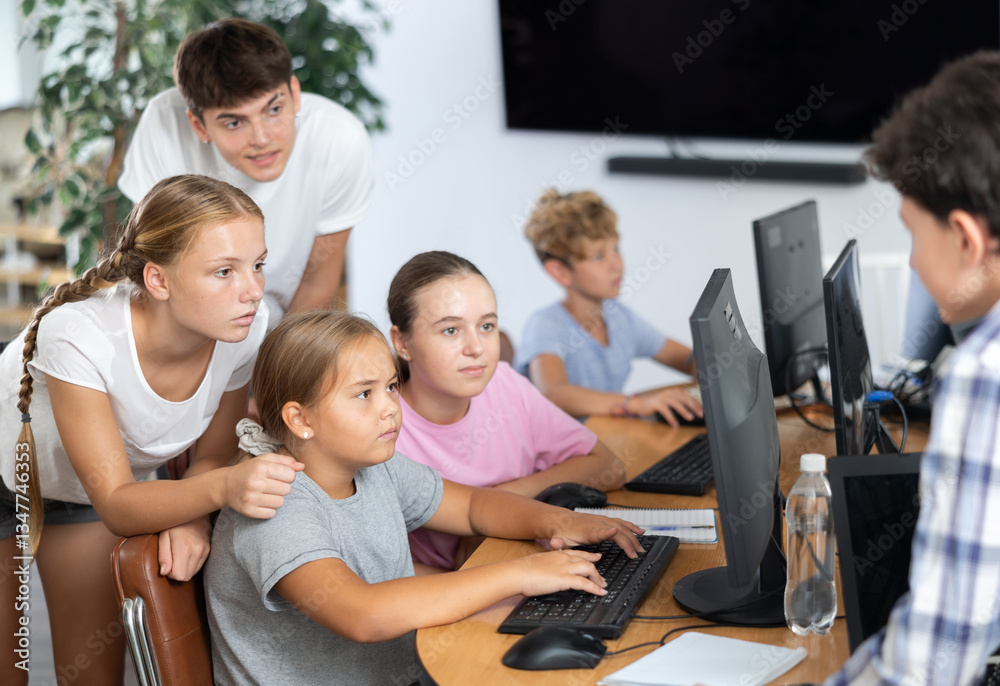 Group of children students learn to work with computer at lesson Group of children students learn to work with computer at lesson