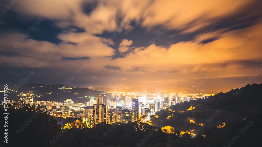 Obraz premium Night cityscape panorama with illuminated city nestled in a valley dramatic cloudscape