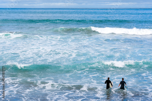 Surfers entering the sea