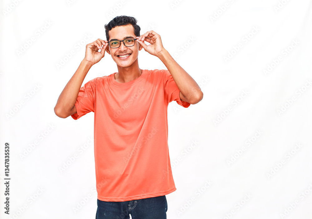 Smiling young man adjusts eyeglasses with a playful attitude on clean background Smiling young man adjusts eyeglasses with a playful attitude on clean background