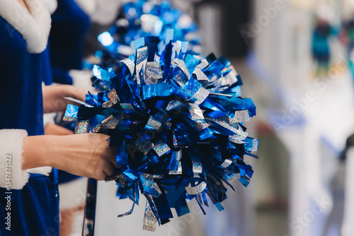 Photography Female cheerleaders group in action, blue and white uniform with pom-pom, audien