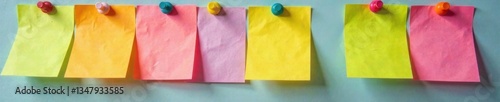 Colorful sticky notes with pins stuck on them in a bulletin board, fun, sticky notes, colorful