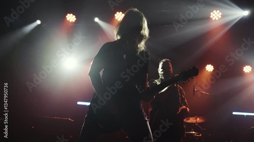 Guitarist performing energetically on stage in slow motion