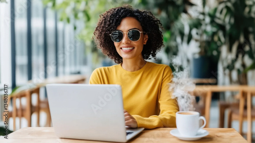 Female leader online working with laptop in modern minimalist Coworking​ Space cafe