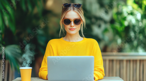 Female leader online working with laptop in modern minimalist Coworking​ Space cafe