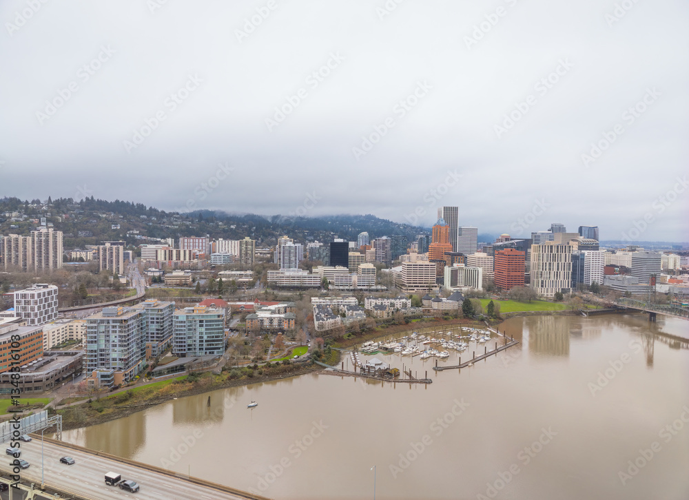 Fototapeta premium A city with a river running through it and a bridge over it